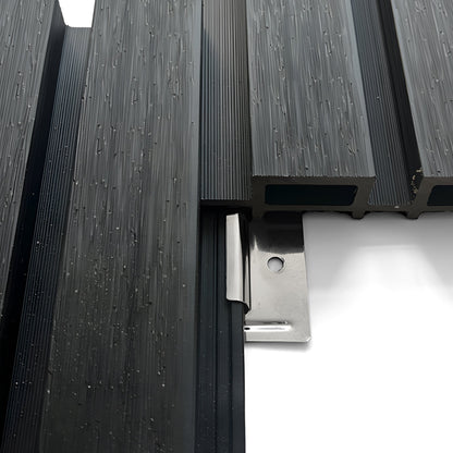 Close-up of Landmark Decor Exterior WPC Panel Clips securing black composite decking boards with a silver metal hidden fastener on a white background.