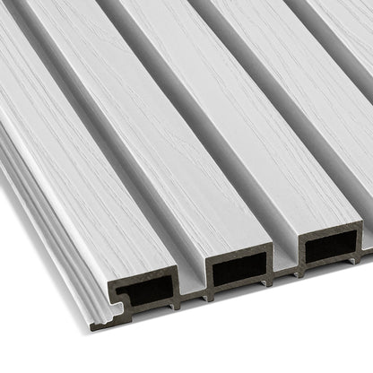 Close-up of four Arctic Frost Exterior WPC Panels by Landmark Decor—light gray, wood-grain textured rectangles with ridged edges and hollow interiors, arranged side by side—perfect for outdoor wall decoration.