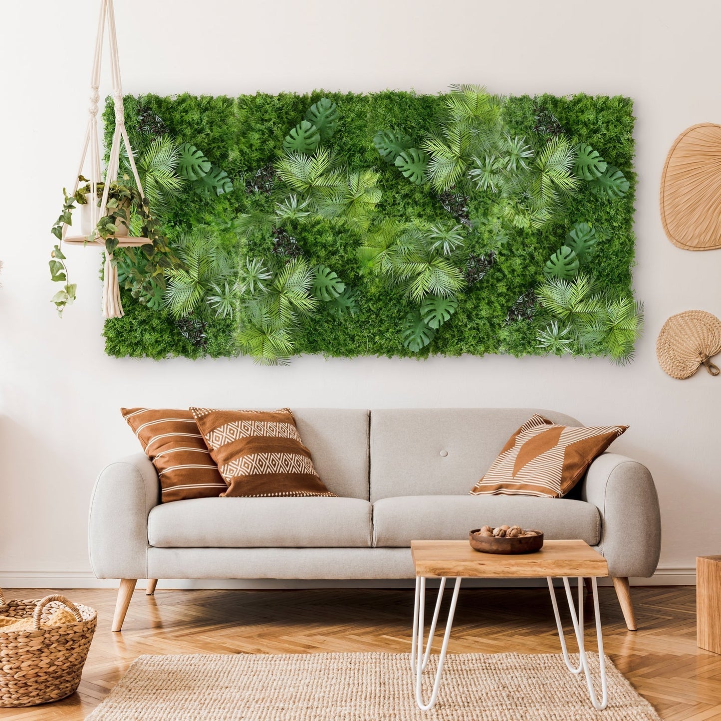 A modern living room with a beige sofa, patterned pillows, and Landmark Decor's Tropical Green Grass Wall above the couch. A hanging plant and wicker accents bring natural charm to the vibrant green feature in the space.