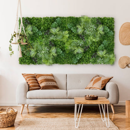 A modern living room with a beige sofa, patterned pillows, and Landmark Decor's Tropical Green Grass Wall above the couch. A hanging plant and wicker accents bring natural charm to the vibrant green feature in the space.