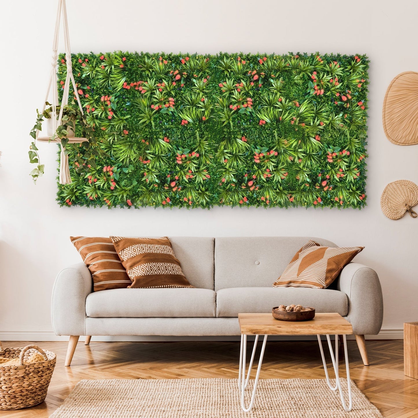 Living room with a gray sofa, patterned pillows, a white coffee table, and decorative wall panels featuring the Landmark Decor Tropical Floral Grass Wall—a large rectangular artificial greenery—hanging above the couch.