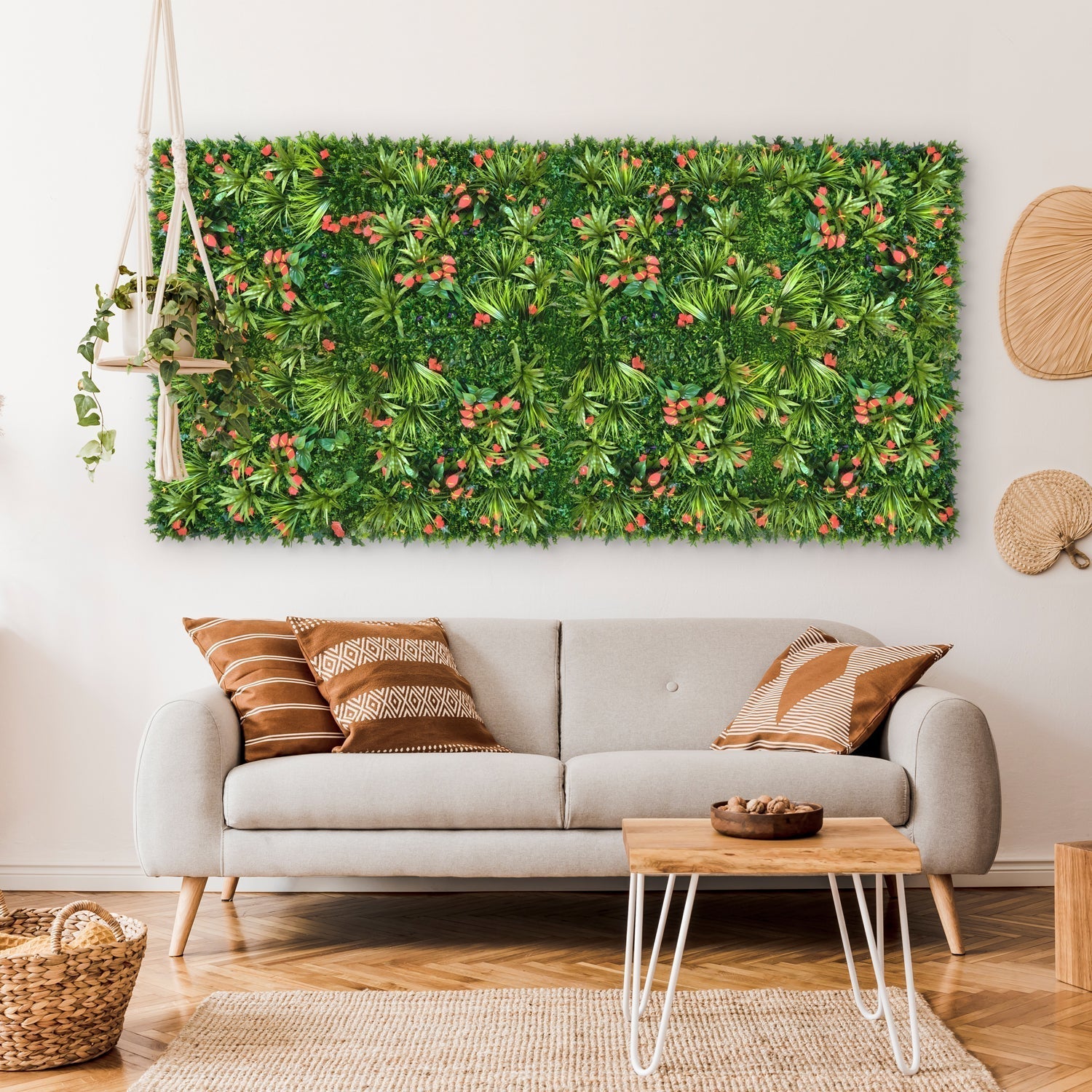 Living room with a gray sofa, patterned pillows, a white coffee table, and decorative wall panels featuring the Landmark Decor Tropical Floral Grass Wall—a large rectangular artificial greenery—hanging above the couch.