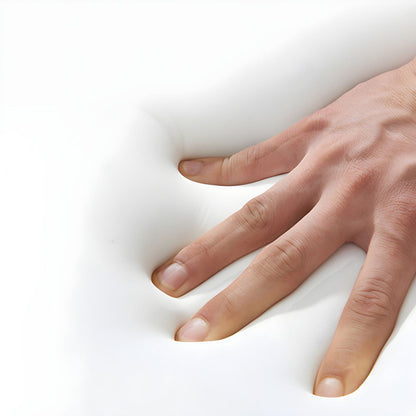 A hand presses on a white memory foam surface in The St. Tropez Collection by Landmark Decor, creating an indentation that highlights the foams ability to mold to shapes—perfect for crafting flexible, weather-resistant alfresco dining furniture.