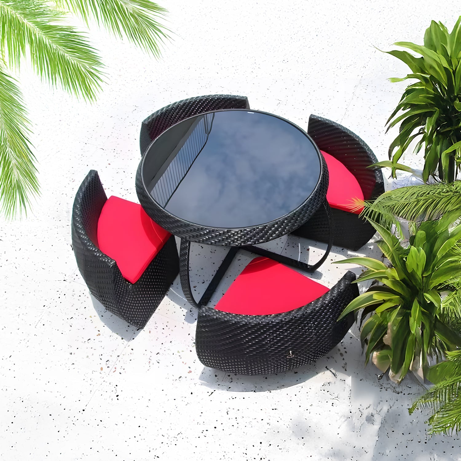 The Midnight Riviera Collection by Landmark Decor features a circular glass-top table and four black wicker chairs with red cushions, perfect for alfresco dining on a speckled white surface. Palm leaves frame the scene, adding tropical charm to your outdoor space.
