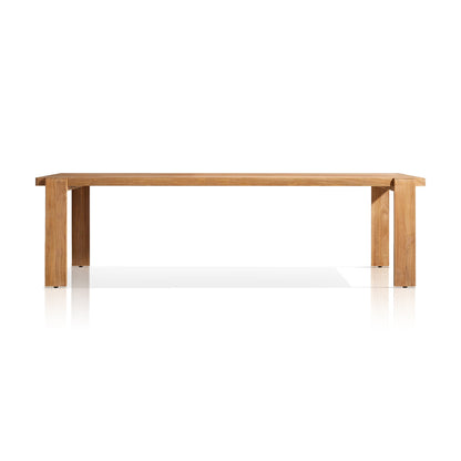The Grove Retreat Collection by Landmark Decor features a minimalist wooden dining table, ideal for alfresco dining. It has a rectangular top, four straight legs, and is crafted from weather-resistant materials with a natural finish and clean lines against a white background.
