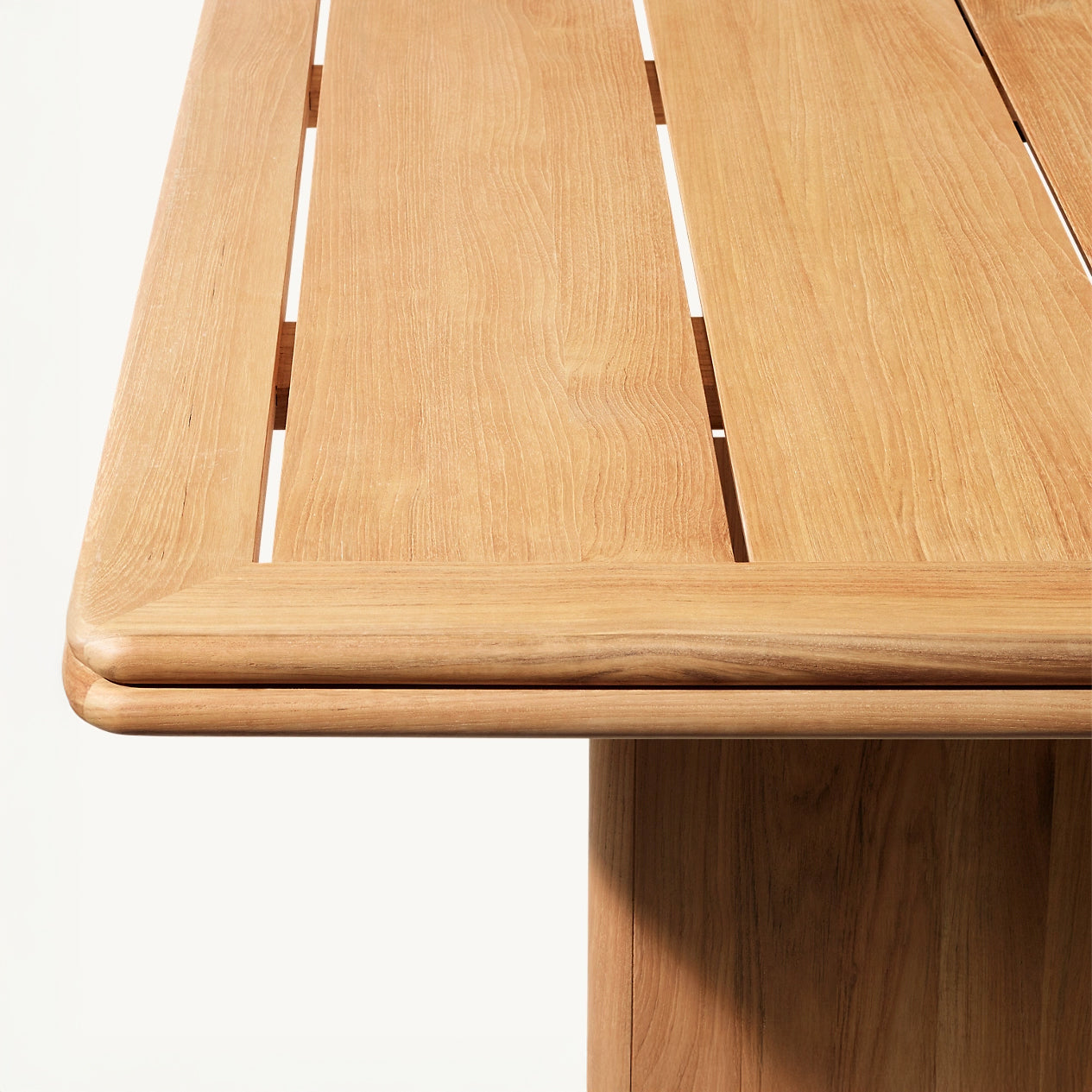 The Amber Ridge Collection by Landmark Decor features a light wooden table with a smooth surface and horizontal slats, ideal for alfresco dining. Its visible wood grain enhances its natural, elegant design, making it a weather-resistant piece perfect for outdoor settings.