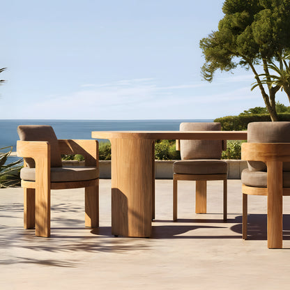 The Pacific Shoreline Collection by Landmark Decor features a wooden outdoor dining set with four cushioned chairs surrounding a rectangular table. Built from weather-resistant materials, its ideal for alfresco dining on a sunny patio overlooking serene coastal views.