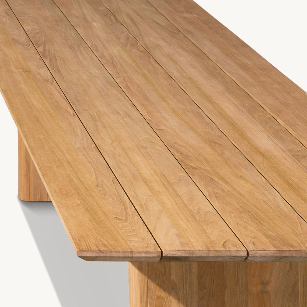 The Summer Solstice Collection by Landmark Decor features a rectangular wooden table with a plank-style surface and natural finish, perfect for outdoor dining. Its craftsmanship is highlighted by a visible wood grain pattern and weather-resistant materials ideal for alfresco settings.