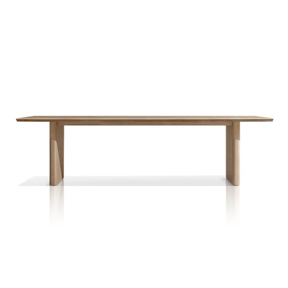 The Summer Solstice Collection by Landmark Decor features a minimalist wooden table with a rectangular top and sturdy legs, ideal for alfresco dining. Set against a white background, its clean lines and natural wood finish highlight elegance and functionality with weather-resistant materials.