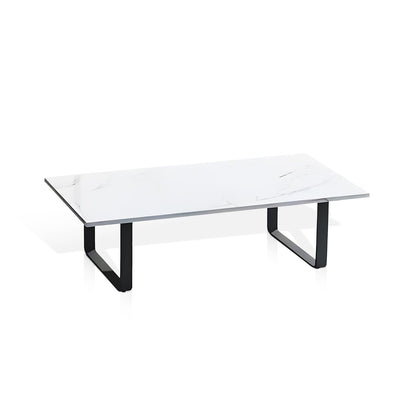The Sierra Luxe Collection by Landmark Decor features a rectangular marble coffee table with a white surface and subtle gray veining on black U-shaped metal legs, ideally complementing an outdoor sofa with weather-resistant cushions for a stylish, durable patio setup.
