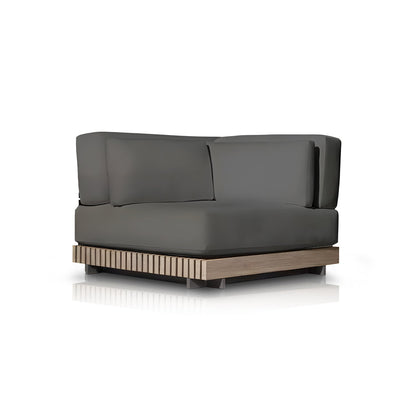 The Palazzo Tranquillo Collection by Landmark Decor features a modern armchair with weather-resistant dark gray cushions and a low wooden base with vertical slats, showcasing clean lines in its minimalist design, ideal for outdoor use on reflective white surfaces.