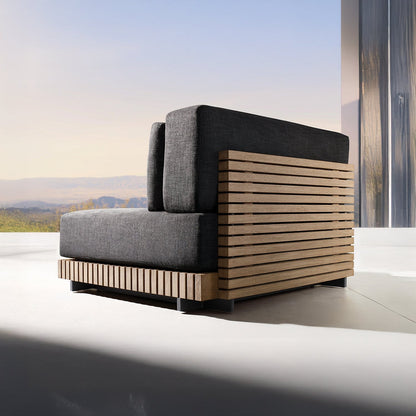 The Palazzo Tranquillo Collection by Landmark Decor features a modern chair with weather-resistant cushions and a wooden slatted frame. Positioned in a minimalist space with large windows, it offers views of mountains and blue sky, creating a serene ambiance.