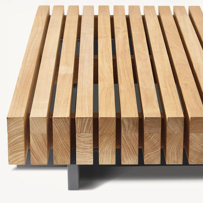 The Landmark Decor Palazzo Tranquillo Collection bench showcases a minimalist design with wooden slats, an all-weather metal frame, and a light finish that highlights the wood grain, ideal for outdoor settings.
