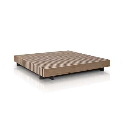The Palazzo Tranquillo Collection by Landmark Decor is a minimalist wooden platform bed set against a white background, showcasing a low-profile design with a slatted pattern and dark legs, reminiscent of outdoor sofas with all-weather frames.