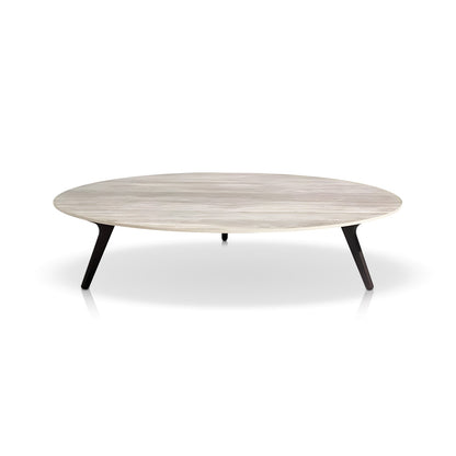 The Marbella Retreat Collection by Landmark Decor features a round, minimalist coffee table with a light wood surface and three angled black legs, set against a white backdrop to perfectly complement outdoor sofas with all-weather frames.