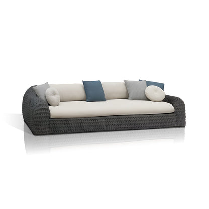 The Palermo Terra Collection by Landmark Decor features a modern outdoor sofa with a woven dark frame and weather-resistant cream cushions, complemented by blue, white, and light gray pillows. Its sleek all-weather design stands elegantly against a plain white background.