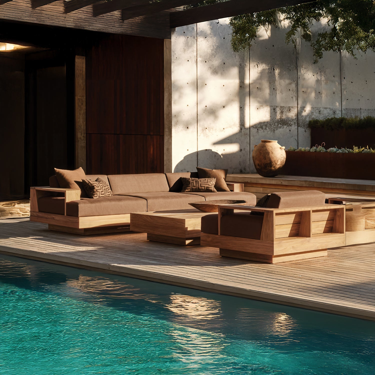 The outdoor seating area features the Timber Cove Collection by Landmark Decor, with modern wooden furniture and outdoor sofas with weather-resistant cushions and brown pillows. Set on a deck by a turquoise pool, it includes a large ceramic pot, partially shaded by a pergola.