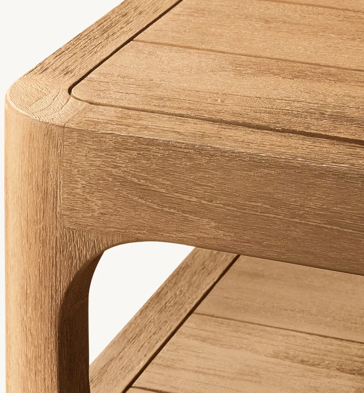 Close-up of the Serene Arc Collection table by Landmark Decor, highlighting smooth, rounded edges and natural wood grain. Its minimalist design with subtle grooves harmonizes beautifully with outdoor sofas that have all-weather frames.