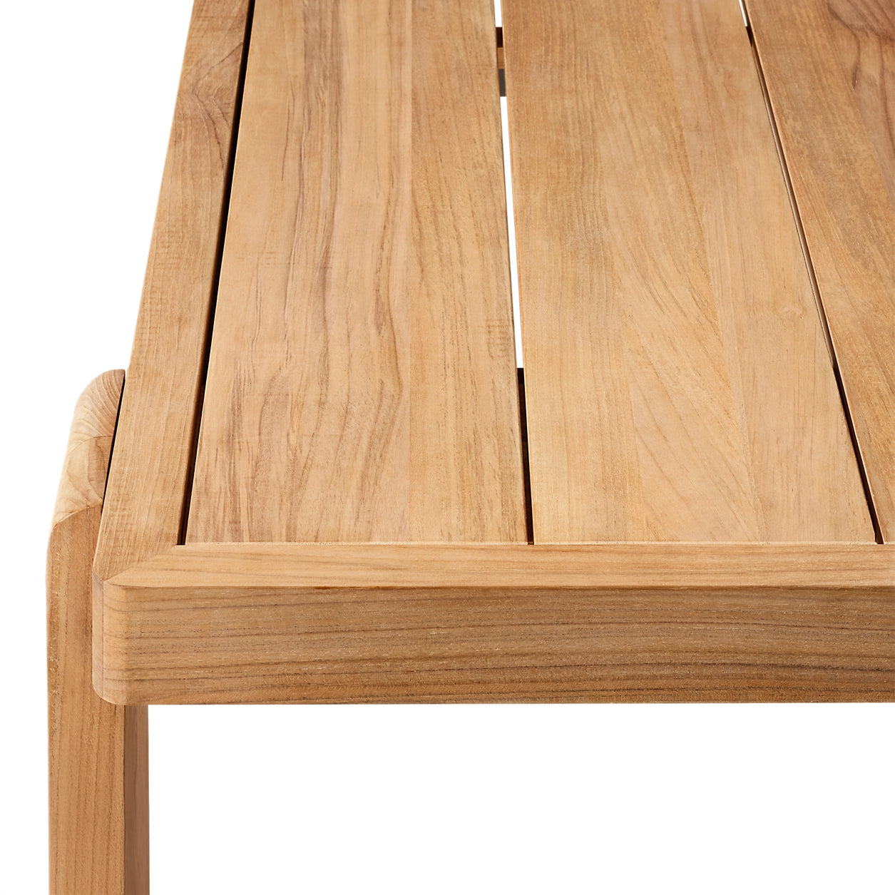 A close-up of The Grove Retreat Collection wooden table by Landmark Decor reveals a natural-finish, slatted surface and modern design, crafted from weather-resistant materials for stylish and durable alfresco dining.