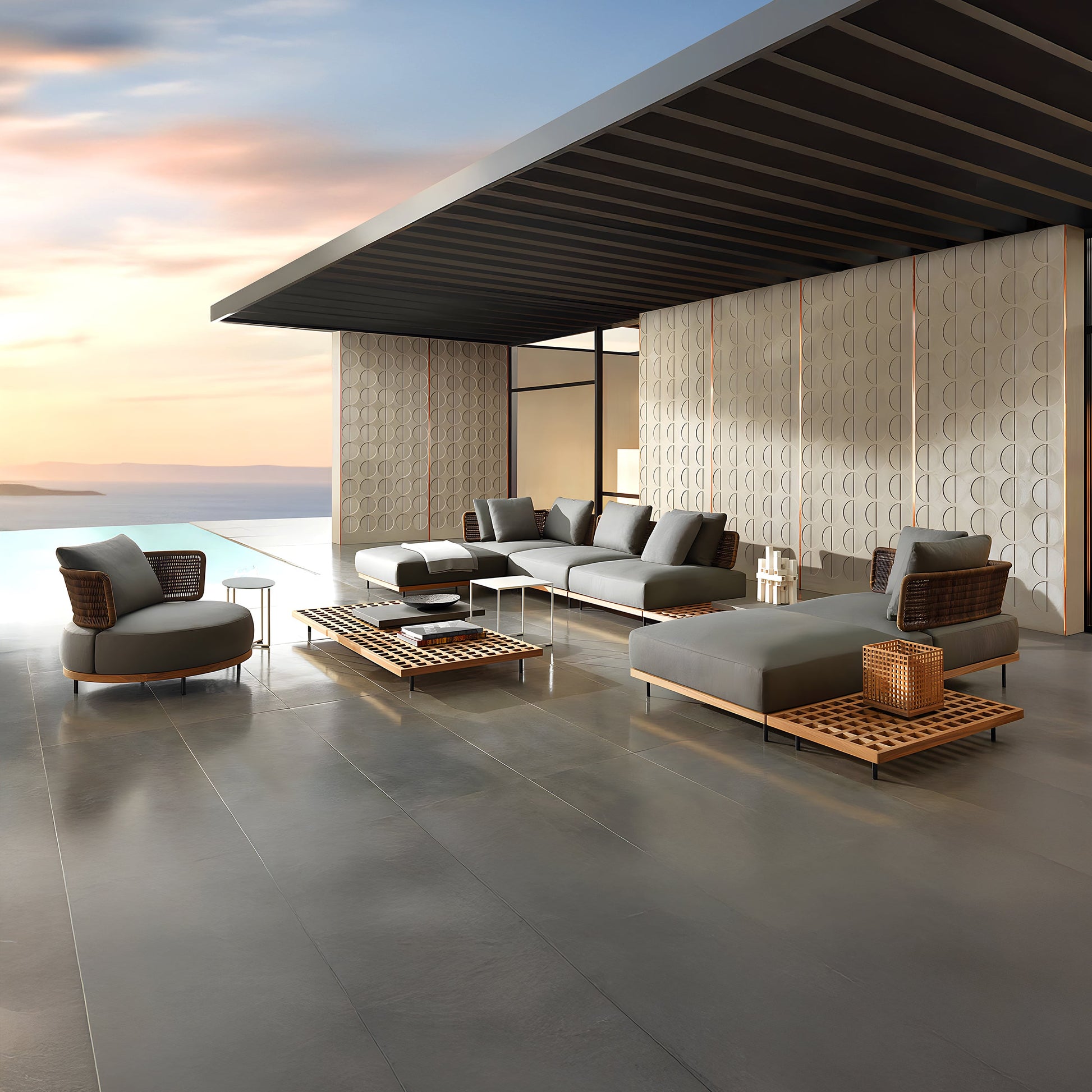 Experience the modern elegance of the Oceanview Oasis Collection by Landmark Decor, featuring gray sectional outdoor sofas and chairs with weather-resistant cushions, low wicker-accented coffee tables, and a minimalist shade structure overlooking an infinity pool with a sunset view.