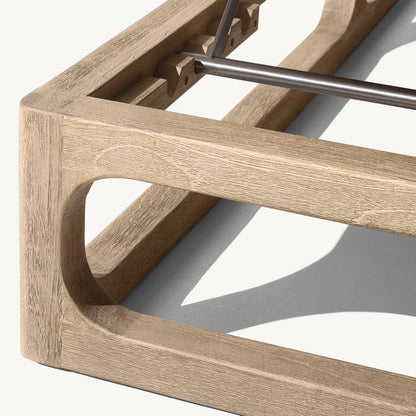 Close-up of the Bali Luxe Retreat Set by Landmark Decor, a minimalist wooden bed frame crafted from premium materials. The light-colored wood features a smooth finish and a top metal support bar. Its sleek design evokes the easy elegance of outdoor living as its shadow dances below.