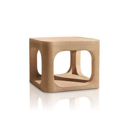 The Bali Luxe Retreat Set by Landmark Decor includes a modern, light wood cubic side table with rounded edges. Perfect for outdoor spaces, it is crafted from premium materials and features open square cutouts on each side, creating an elegant hollow interior on a reflective surface.