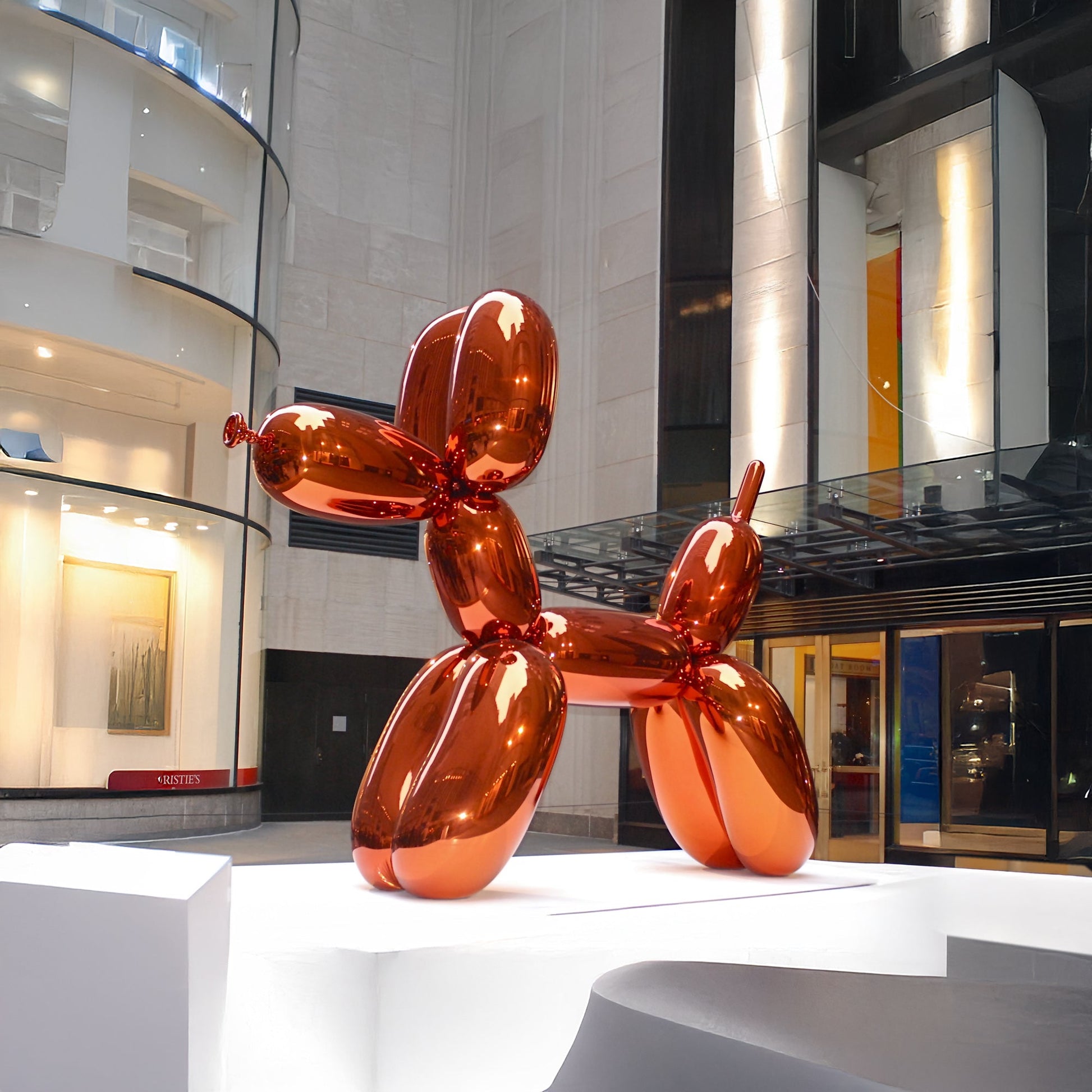 The Landmark Decor Balloon Dog is a large, shiny orange metallic sculpture on a white platform, perfect as a vibrant statement piece for modern indoor spaces and art lovers.
