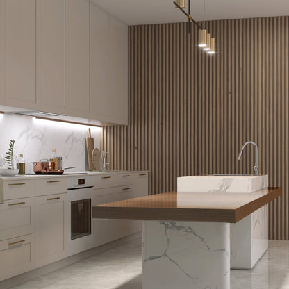 Modern kitchen with white cabinets, marble countertops, an island with a wood top and built-in sink, minimalist pendant lights, and a Landmark Decor Taupe Interior WPC Panel Corner accent wall for unique style.