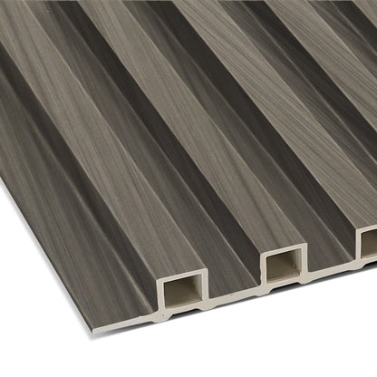 A close-up of the Ebony Chevron WPC Fluted Slat Wall Panel by Landmark Decor shows its brown, grooved, rectangular design with lengthwise hollow sections—perfect for stylish wall cladding or modern interior panels.
