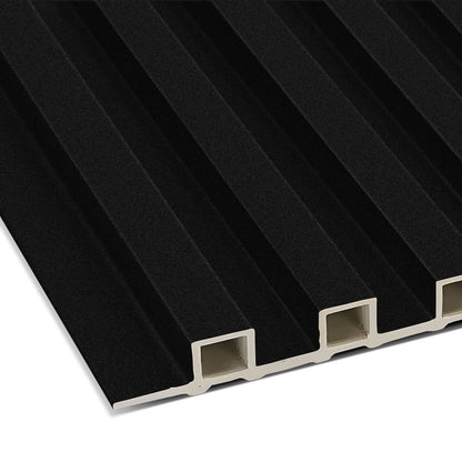 A close-up of the Absolute Noir WPC Fluted Slat Wall Panel by Landmark Decor shows its black grooves, four rectangular hollow sections, and white core—ideal for stylish accent walls or modern interiors.