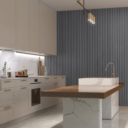 Modern kitchen with white cabinets, marble countertops, a wood-topped island, under-cabinet lighting, and an eye-catching accent wall featuring Landmark Decor's Space Gray WPC Fluted Slat Wall Panel.